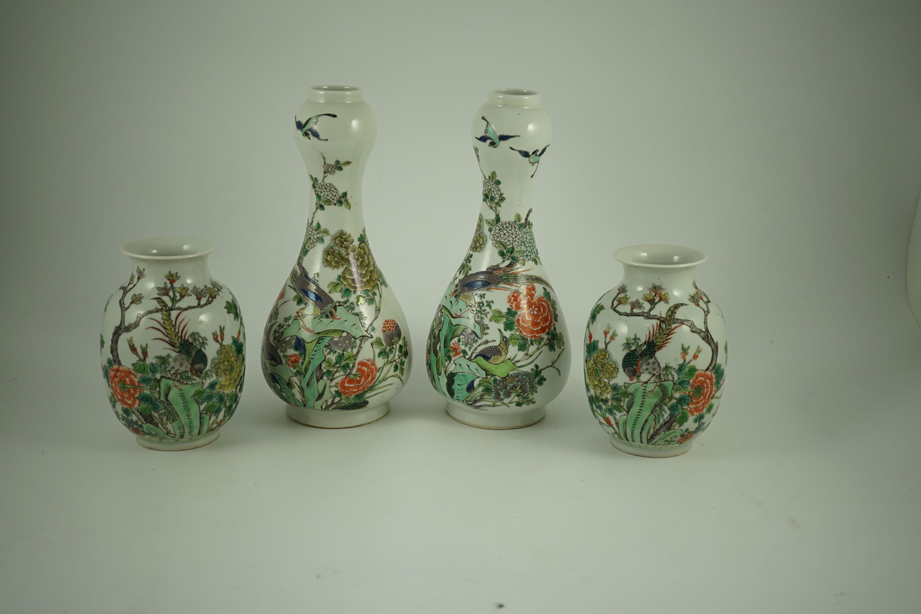A garniture of four Chinese famille verte vases, 19th century, 31 cm and 17.5 cm high, one small vase cracked to neck